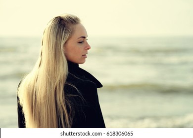 Portrait of a beautiful blonde outdoor on the sea 