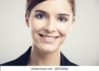 Portrait Of A Beautiful Blonde Woman With Blue Eyes Smiling