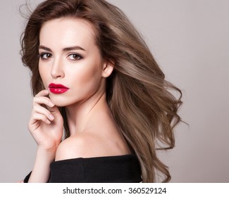 Portrait Of Beautiful Blonde Woman With Curly Hairstyle And Bright Makeup, Perfect Skin, Skincare, Spa, Cosmetology. Sexy Vogue Woman Face, Sensual Beauty Girl Model. Natural Look. Studio, Isolated.