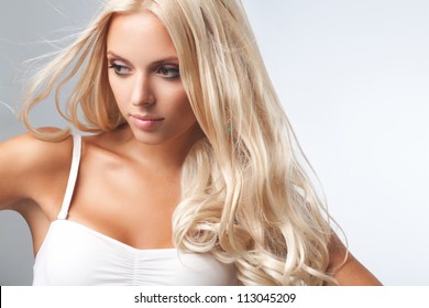 Portrait of beautiful blonde woman . Healthy Long Blond Hair. Hair Extension