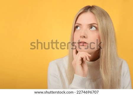 portrait of a beautiful blonde woman with a thoughtful pose