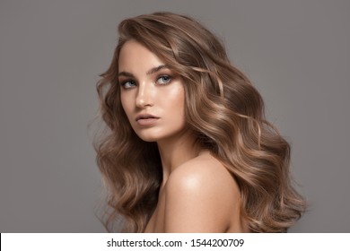 Portrait of beautiful blonde woman. Volume hairstyle.