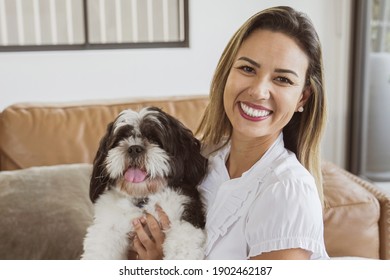 Portrait of beautiful Brazilian woman and her pet shih tzu dog at home, best friend, family love  - Shutterstock ID 1902462187