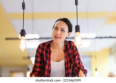 Portrait Of A Beautiful Brunette Business Woman Wearing Red Shirt In A Modern Office.