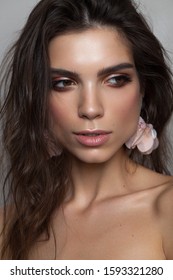 Portrait Of A Beautiful Brunette Girl With Hazel Eyes And Square Jaw And Chin. Perfect Skin, Light Professional Make Up.