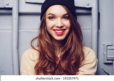 Portrait of a beautiful brunette girl outdoors in hat, lifestyle