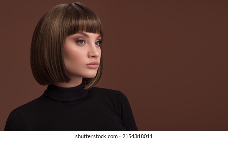Portrait of a beautiful brunette girl with a short haircut. Brown background. - Shutterstock ID 2154318011