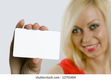 Portrait of a beautiful business woman holding a blank white notecard (business card)