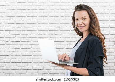 Portrait of beautiful businesswoman against the brick wall