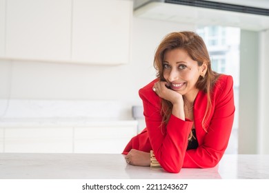 Portrait Of Beautiful Businesswoman In Office Wearing Red Suit Jacket