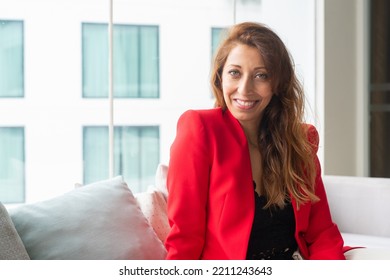 Portrait Of Beautiful Businesswoman In Office Wearing Red Suit Jacket