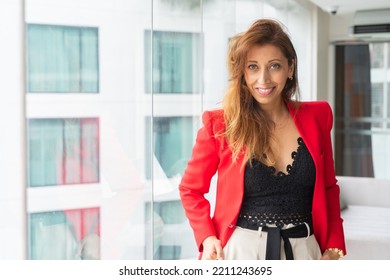 Portrait Of Beautiful Businesswoman In Office Wearing Red Suit Jacket