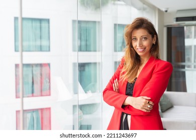 Portrait Of Beautiful Businesswoman In Office Wearing Red Suit Jacket