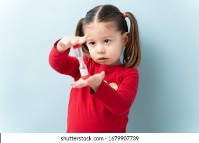 Portrait Of A Beautiful Caucasian Girl Holding A Sand Timer And Practicing Self Control In A Studio