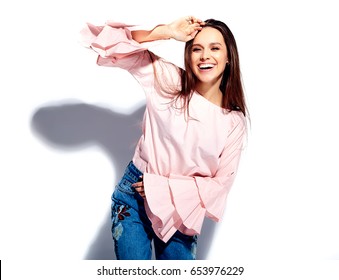 Portrait of beautiful caucasian smiling brunette woman model in bright pink blouse and summer stylish blue jeans with flowers print isolated on white background