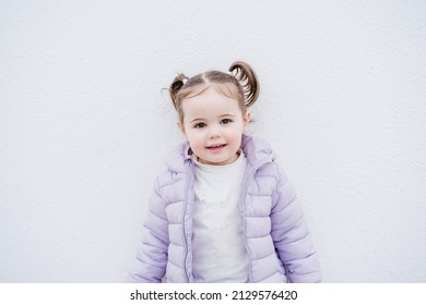 Portrait Of Beautiful Caucasian Two Year Old Baby Girl Smiling Over White Background. Childhood