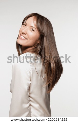 portrait of beautiful Caucasian woman in her 20s smiling and posing on white background