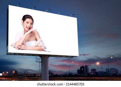 Portrait of beautiful charming young Asian woman posing facial and sitting with white table advertise on billboard blank for outdoor advertising poster or blank billboard for advertisement. - Shutterstock ID 2144485705
