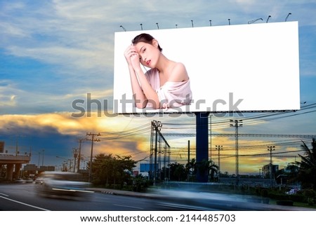 Portrait of beautiful charming young Asian woman posing facial and sitting with white table advertise on billboard blank for outdoor advertising poster or blank billboard for advertisement.