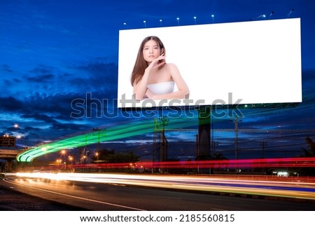 Portrait of beautiful charming young Asian woman posing facial and sitting with white table advertise on billboard blank for outdoor advertising poster or blank billboard for advertisement