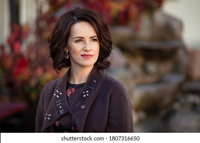 Portrait Of A Beautiful Confident Adult Woman. Autumn Time. Attractive Female Not  Looking  Into The Camera. Copy Space