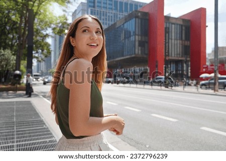Portrait of beautiful confident Brazilian woman in front of the MASP on Paulista Avenue, Sao Paulo, Brazil
