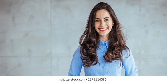 Portrait of beautiful confident smiling businesswoman standing with arms crossed in the office and looking at camera. Cropped portrait of an attractive young businesswoman standing alone  - Shutterstock ID 2278114395