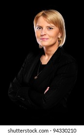 A Portrait Of A Beautiful Confident Woman Standing Over Black Background