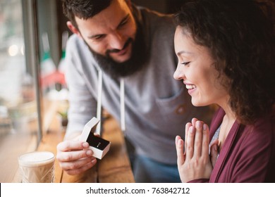 Portrait Of A Beautiful Couple Enjoying Each Other's Company In A Cafe, An Offer To Get Married. Gives A Diamond Ring.