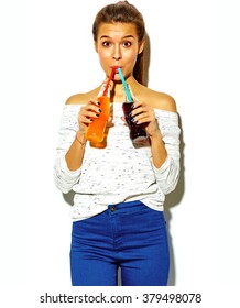 Portrait Of Beautiful Crazy Smiling Brunette Woman Girl In Casual Blue Hipster Summer Clothes With No Makeup Isolated On White Drinking Soda From Two Bottles With Straw