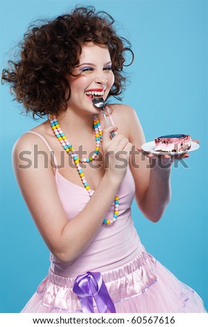 portrait of beautiful curly brunette girl with cake