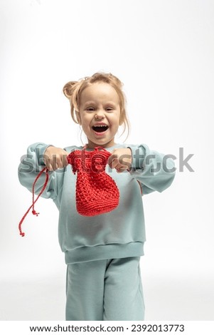 Portrait of beautiful cute little toddler girl. Child with funny face in mint sweatshirt. Pretty smile kid in studio on white background. High quality photo