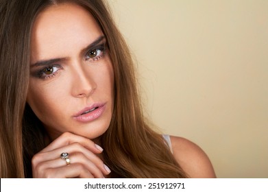 Portrait of beautiful dark hair spa woman on brown background - Shutterstock ID 251912971