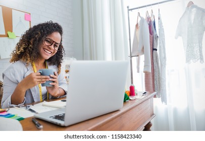 Portrait Of Beautiful Designer Black Woman Work With Computer Tailer Fabric Fashion Small Business Workshop Office. Young Owner Entrepreneur Creative Girl In Textile Garment Business Startup Concept