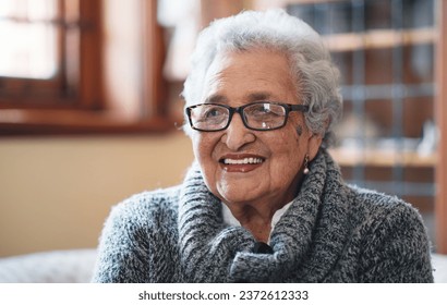 Portrait beautiful elderly woman smiling sitting on sofa at home enjoying retirement - Shutterstock ID 2372612333