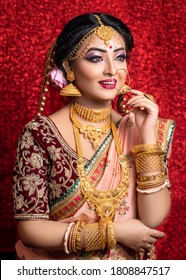 Portrait of a Beautiful Elegant Female Model in Traditional Ethnic Indian Bridal Costume with Makeup and Heavy Jewellery.