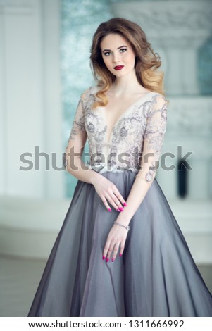 A portrait of a beautiful elegant woman in the evening dress. Fashion, evening dresses for events.