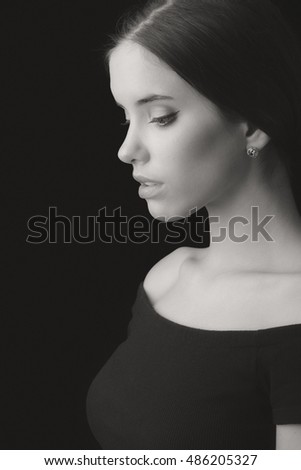 Portrait of beautiful elegant young woman isolated on black background.