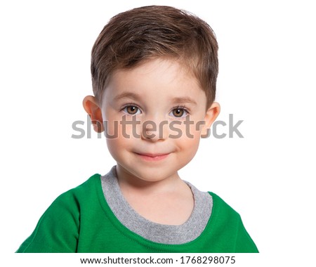 Portrait of a beautiful European boy 2 years old. A beautiful and happy child. A child's smile. Isolated on a white background in a green t-shirt.