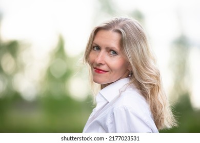 Portrait of a beautiful European middle-aged woman. Fifty-year-old blonde woman with a well-groomed face close-up.
