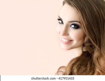 Portrait Of Beautiful Fashion Model With Bright Eye Make Up And Long Wavy Hair.  Perfect Fresh Skin And Long Eyelashes.  Make Up And Hair. Lashes.