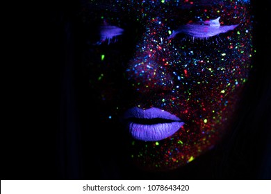 Portrait of Beautiful Fashion Woman in Neon UF Light. Model Girl with Fluorescent Creative Psychedelic MakeUp, Art Design of Female Disco Dancer Model in UV