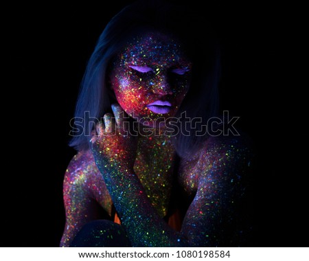 Portrait of Beautiful Fashion Woman in Neon UF Light. Model Girl with Fluorescent Creative Psychedelic MakeUp, Art Design of Female Disco Dancer Model in UV