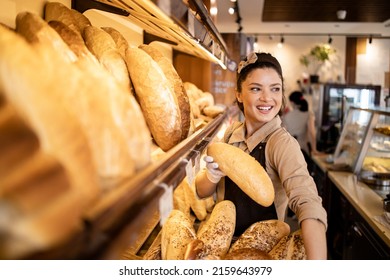 Portrait of beautiful female baker working in bakery shop. - Powered by Shutterstock