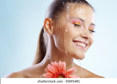 Portrait of beautiful female with flowing water on her face