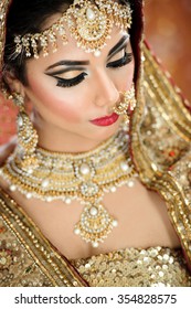 Portrait Of A Beautiful Female Model In Traditional Indian Bridal Costume With Jewellery And Makeup