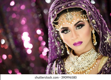 Portrait of a Beautiful Female Model in Traditional Indian Asian Bridal Wedding costume with makeup and jewellery