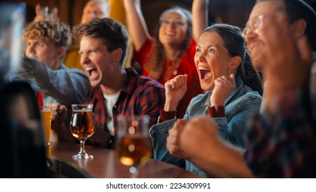 Portrait of a Beautiful Female Sitting at a Pub Counter with Group of Diverse Friends, Watching and Cheering for a Live Soccer Match. Supportive Fans Cheering, Applauding, Shouting and Drinking Beer. - Powered by Shutterstock