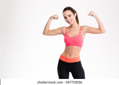 Portrait of a beautiful fitness woman showing her biceps isolated on a white background - Powered by Shutterstock