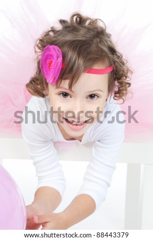 Portrait of beautiful funny little girl with pink balloon